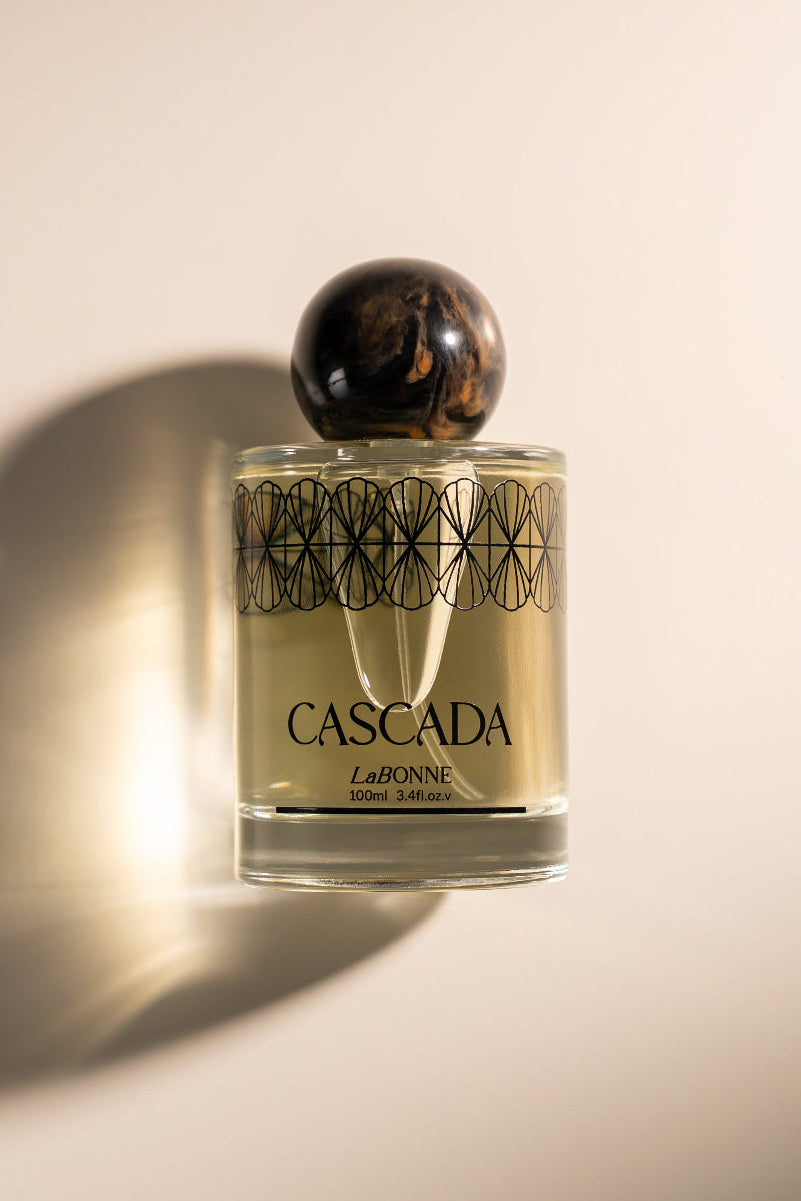 Perfume bottle labeled 'Cascada' on a beige background